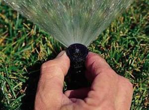 one of our Fairfield sprinkler installation techs optimizing a sprinkler head